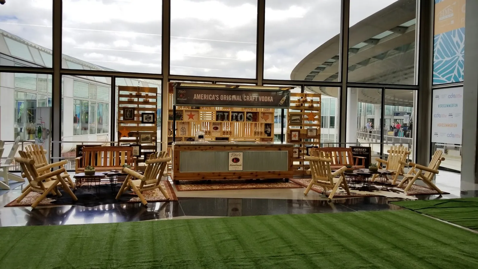 Wooden bar and seating installation in a bright glass-walled venue