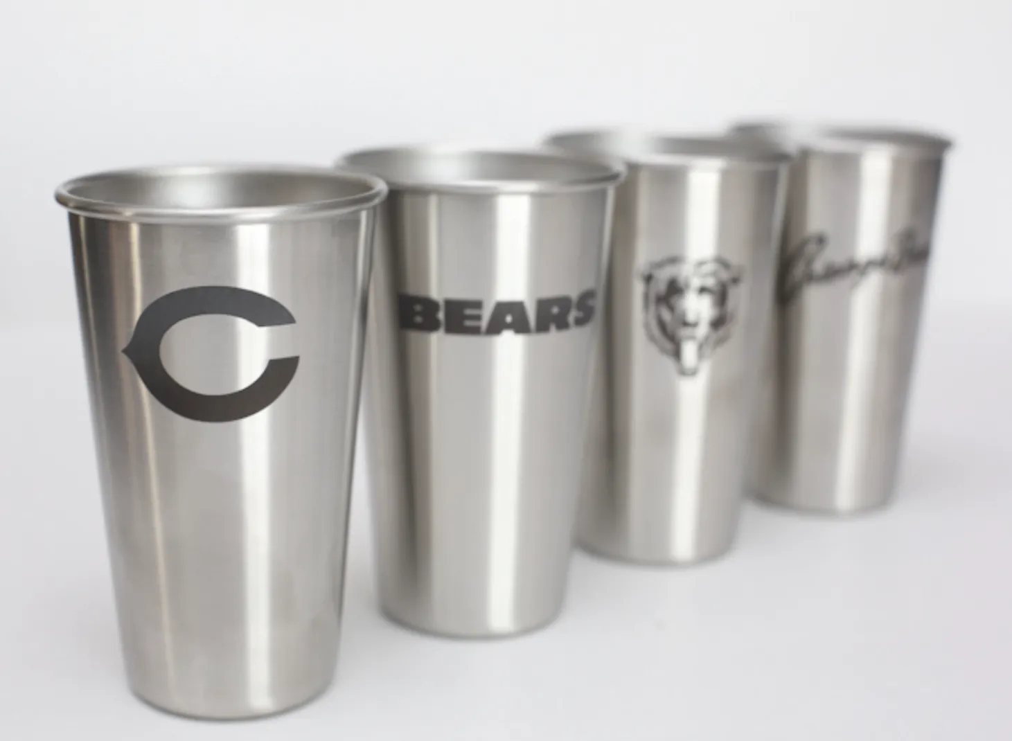 Three brushed metal Chicago Bears tumblers with different team marks