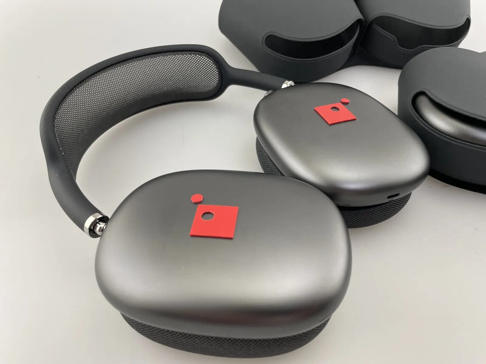 Space gray headphones decorated with red impact marks