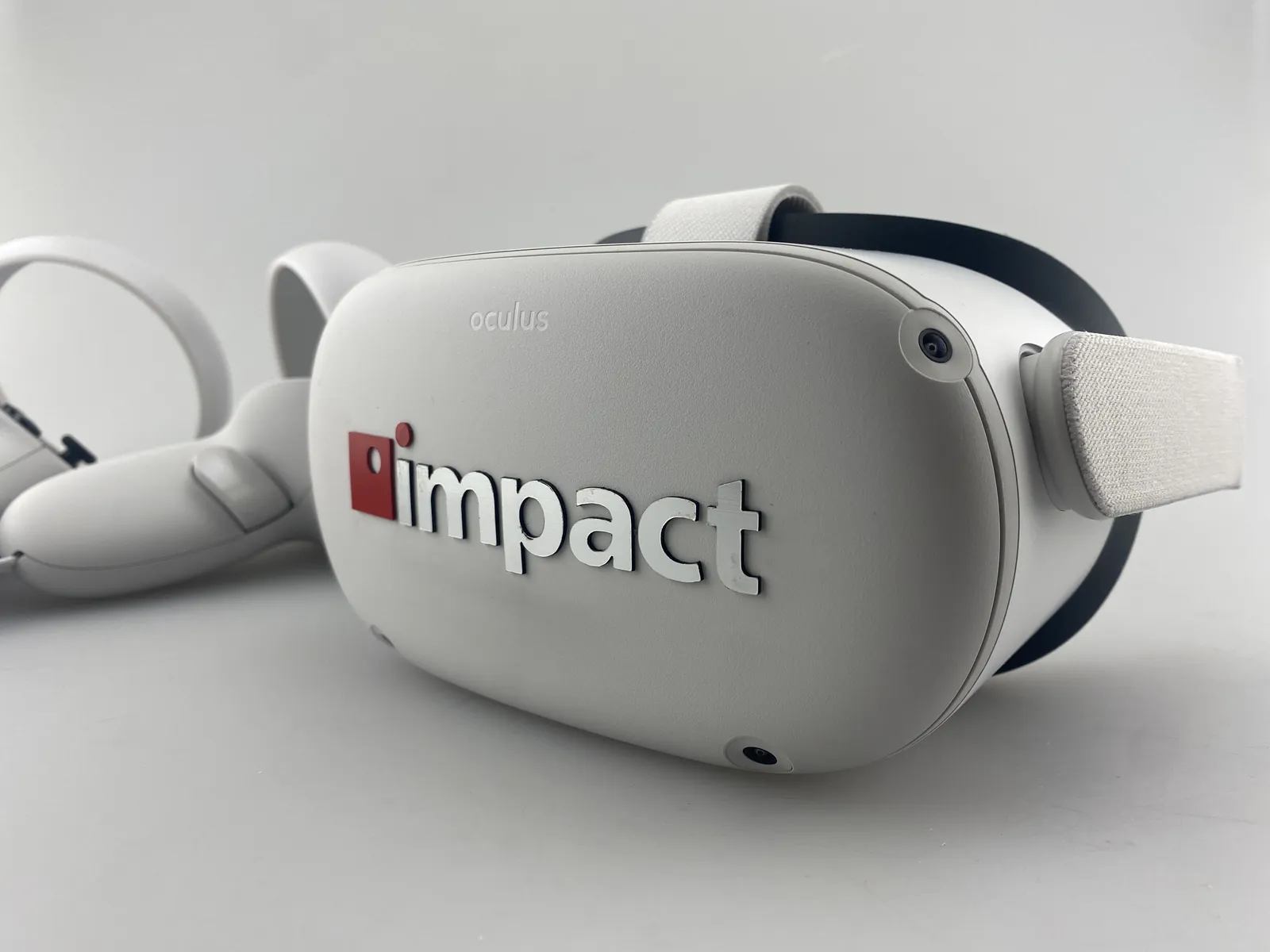 White virtual reality headset with a raised impact logo