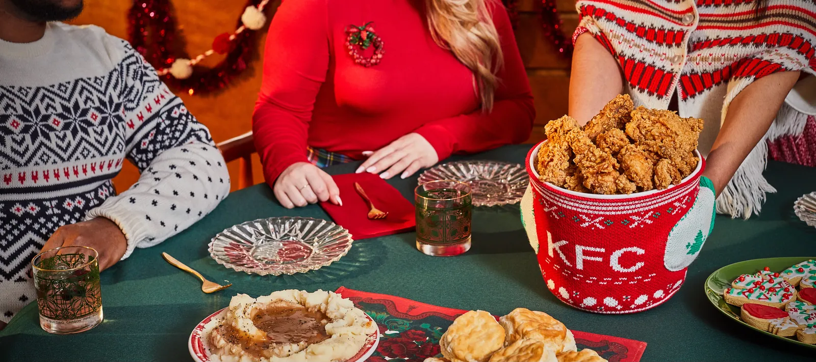KFC knit bucket cozy at a holiday table with festive knitwear